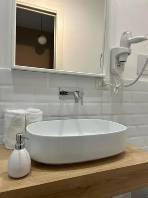 a bathroom with a white sink and a mirror at IL NINFEO San Giovanni ROMA in Rome