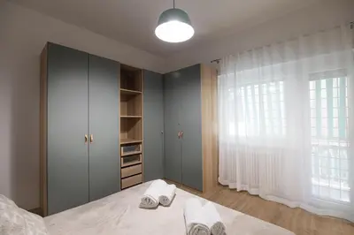 a bedroom with a bed and a large window at Sofia’s home in Rome