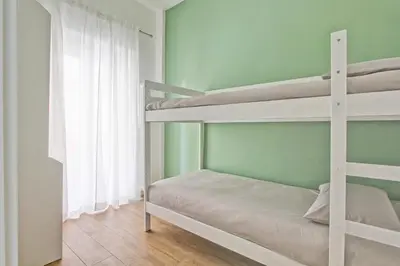 a bedroom with two bunk beds and a window at Sofia’s home in Rome