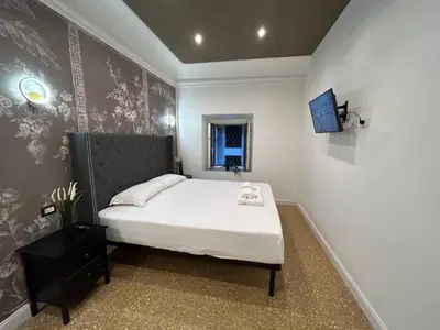 a small bedroom with a bed and a window at Raffaello's Place in Rome