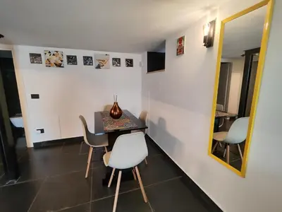a dining room with a table and chairs and a mirror at Il quattro e l'otto in Rome