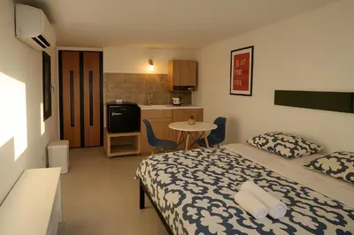 a bedroom with a bed and a small kitchen at Il quattro e l'otto in Rome