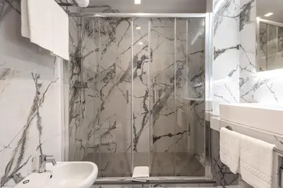 a bathroom with a shower and a sink at Home at Rome Luxury Navona Guesthouse in Rome