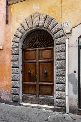 a large wooden door on a building at Home at Rome Luxury Navona Guesthouse in Rome