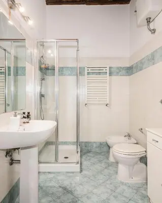 a bathroom with a sink and a toilet and a shower at Suites Campo de' Fiori - Zen18-19-20 in Rome