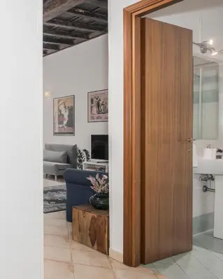 a door leading into a living room with a couch at Suites Campo de' Fiori - Zen18-19-20 in Rome