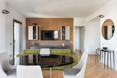 a living room with a table and a couch at Idyllia - Lumina rooftop penthouse in Trastevere in Rome