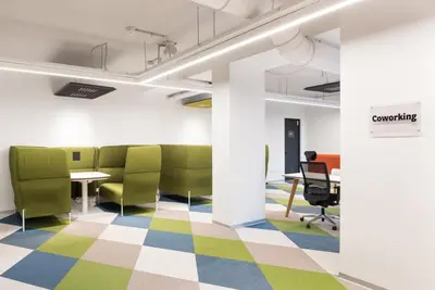 an office with green chairs and desks and a checkered floor at Idyllia - Lumina rooftop penthouse in Trastevere in Rome