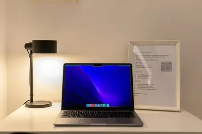 a laptop computer sitting on a desk next to a lamp at Cozy & Central with Private Entrance by NDP rent in Rome