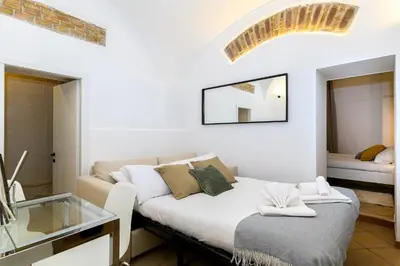 a living room with a couch and a glass table at Cozy & Central with Private Entrance by NDP rent in Rome
