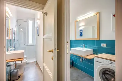 a bathroom with a sink and a washing machine at Borgo Vittorio 2 bdr 2 bath St Peter's in Rome