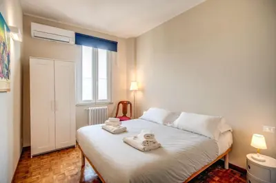 a bedroom with a white bed with towels on it at Borgo Vittorio 2 bdr 2 bath St Peter's in Rome