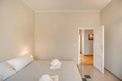 a white room with a bed and a hallway at Borgo Vittorio 2 bdr 2 bath St Peter's in Rome