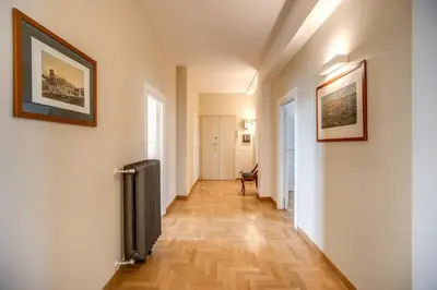 a hallway with white walls and a wooden floor at Borgo Vittorio 2 bdr 2 bath St Peter's in Rome