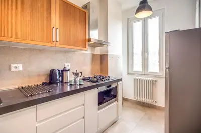 a kitchen with a stove top oven next to a window at Borgo Vittorio 2 bdr 2 bath St Peter's in Rome