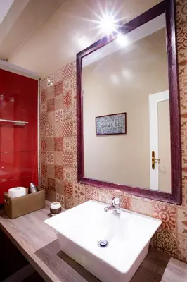 a bathroom with a sink and a large mirror at DOMUS PETRI- CASA A S. PIETRO in Rome