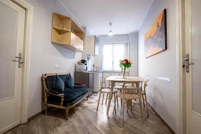 a room with a table and chairs and a kitchen at DOMUS PETRI- CASA A S. PIETRO in Rome