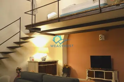 a living room with a couch and a bunk bed at Shabby Loft in Colosseum in Rome