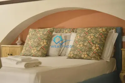 a bed with pillows and towels on it at Shabby Loft in Colosseum in Rome