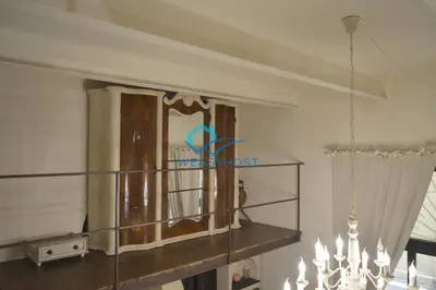 a living room with a chandelier and a shelf at Shabby Loft in Colosseum in Rome