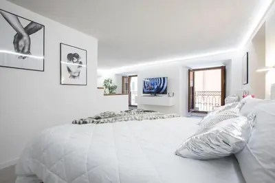 a white bedroom with a large bed and a window at My Piazza Navona Jacuzzi Suite - Top Collection in Rome
