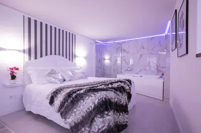 a white bedroom with a bed and a sink at My Piazza Navona Jacuzzi Suite - Top Collection in Rome