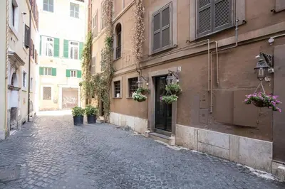 an alley with potted plants on the side of a building at My Piazza Navona Jacuzzi Suite - Top Collection in Rome