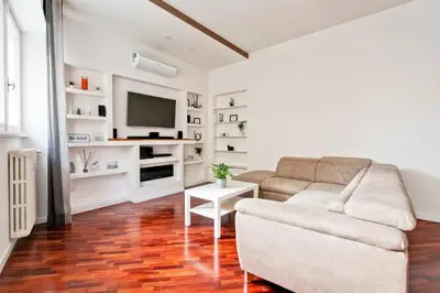 a living room with a couch and a tv at [Vaticano * * * * *] - Luxury Flat in Rome