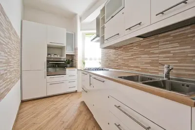 a kitchen with white cabinets and a sink at [Vaticano * * * * *] - Luxury Flat in Rome
