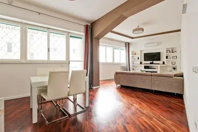 a living room with a table and a couch at [Vaticano * * * * *] - Luxury Flat in Rome