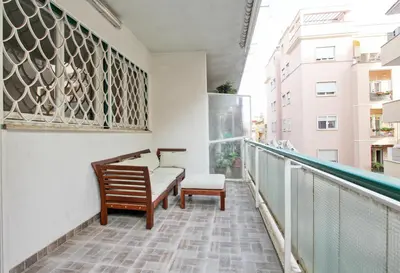 a balcony with a bench and a chair at [Vaticano * * * * *] - Luxury Flat in Rome