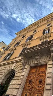 an open window with a view of a building at MICHELANGELO SUITE ROMA GUEST HOUSE camere con vista sulle Terme di Diocleziano e sul Chiostro di Michelangelo in Rome