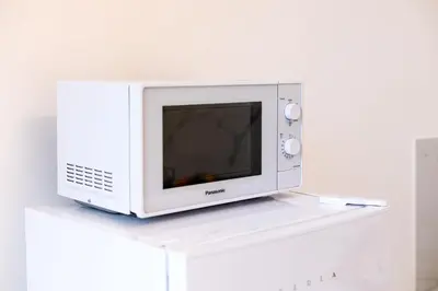 a microwave oven sitting on top of a white shelf at Re di Roma Rooftop in Rome