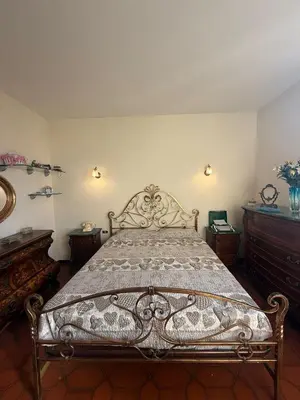 a bedroom with a large bed with a wooden frame at Re di Roma Rooftop in Rome