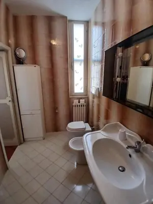 a bathroom with a sink and a toilet at Re di Roma Rooftop in Rome