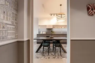 a dining room with a table and chairs in a kitchen at Be Mate Colosseo in Rome