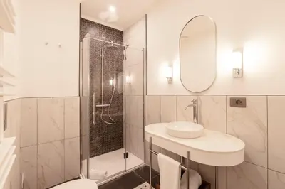 a white bathroom with a sink and a shower at Be Mate Colosseo in Rome