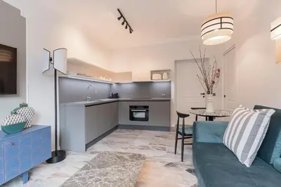 a kitchen and living room with a couch and a table at Be Mate Colosseo in Rome