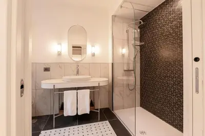 a bathroom with a sink and a shower at Be Mate Colosseo in Rome