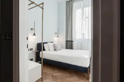 a small bedroom with a bed and a mirror at Be Mate Piazza Navona in Rome