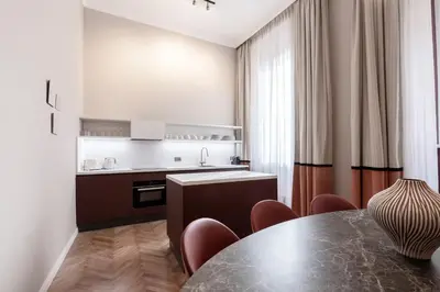 a kitchen with a table and chairs in a room at Be Mate Piazza Navona in Rome