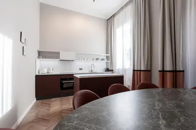 a kitchen with a table and chairs in a room at Be Mate Piazza Navona in Rome
