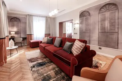 a living room with a red couch and a table at Be Mate Piazza Navona in Rome