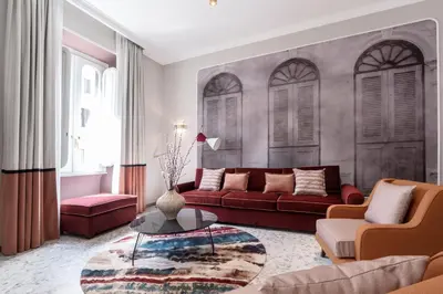 a living room with a red couch and a table at Be Mate Castel Sant'Angelo in Rome