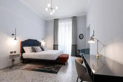 a bedroom with a bed and a table and chairs at Be Mate Castel Sant'Angelo in Rome