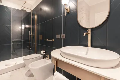 a bathroom with a sink and a toilet and a mirror at Be Mate Castel Sant'Angelo in Rome