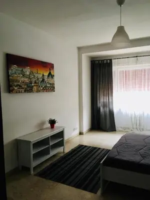 a bedroom with a bed and a desk and a window at La mia casa di Roma in Rome