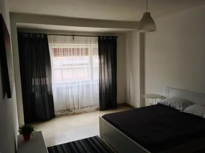 a bedroom with a bed and a large window at La mia casa di Roma in Rome