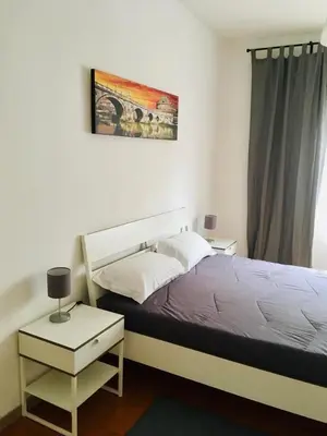 a bedroom with a large bed and a window at La mia casa di Roma in Rome