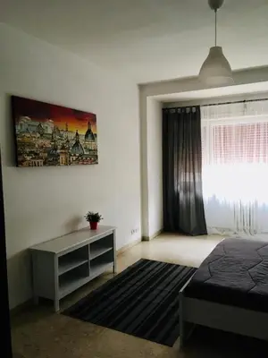 a bedroom with a bed and a desk and a window at La mia casa di Roma in Rome